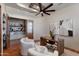 Spacious office with wood floors, a wooden desk, and two modern white upholstered chairs at 4327 E Capricorn Pl, Chandler, AZ 85249
