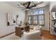 Office with a ceiling fan, modern art, a wood desk, and two white upholstered chairs at 4327 E Capricorn Pl, Chandler, AZ 85249