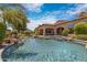 Resort-style pool with a built-in spa, rock features, and covered patio at 4327 E Capricorn Pl, Chandler, AZ 85249