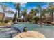 Lush backyard oasis with a beautiful pool, a jacuzzi, mature palms, rock features, and a tranquil waterfall at 4327 E Capricorn Pl, Chandler, AZ 85249