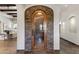 Wine cellar with stone archway and glass door showing extensive wine storage and elegant design at 4327 E Capricorn Pl, Chandler, AZ 85249