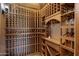 Custom wine cellar with wooden racking system for ample bottle storage and display, plus a built-in counter at 4327 E Capricorn Pl, Chandler, AZ 85249
