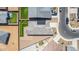 Aerial shot displaying a home's backyard with a putting green, desert landscaping, and solar panels at 4371 E Enmark Dr, San Tan Valley, AZ 85143