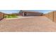 Large backyard features a putting green, brick patio, and ample space for outdoor recreation at 4371 E Enmark Dr, San Tan Valley, AZ 85143