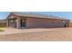 Backyard with a covered patio, brick paving, and low-maintenance landscaping at 4371 E Enmark Dr, San Tan Valley, AZ 85143