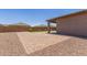 Paver patio leads to low-maintenance backyard with desert landscaping and putting green at 4371 E Enmark Dr, San Tan Valley, AZ 85143