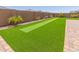 Backyard boasts a putting green and manicured landscaping, perfect for outdoor activities at 4371 E Enmark Dr, San Tan Valley, AZ 85143