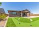 Home showcasing a putting green, covered patio, and modern outdoor living space at 4371 E Enmark Dr, San Tan Valley, AZ 85143