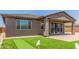 Covered patio with a putting green and beautifully landscaped yard, ideal for entertaining at 4371 E Enmark Dr, San Tan Valley, AZ 85143