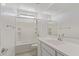 Bright bathroom featuring white vanity, mirror, and shower-tub combo at 4371 E Enmark Dr, San Tan Valley, AZ 85143