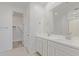 Bright bathroom with double sinks, white cabinets, and a walk-in closet at 4371 E Enmark Dr, San Tan Valley, AZ 85143