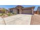 Charming single-Gathering home with a well-manicured front yard, a two-car garage, and stone masonry at 4371 E Enmark Dr, San Tan Valley, AZ 85143