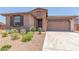 Charming single-Gathering home with a well-manicured front yard, a two-car garage, and stone masonry at 4371 E Enmark Dr, San Tan Valley, AZ 85143