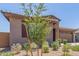 Single-Gathering house featuring a gravel yard with drought-resistant plants and a two-car garage at 4371 E Enmark Dr, San Tan Valley, AZ 85143