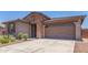Charming single-Gathering home with a well-manicured front yard, a two-car garage, and stone masonry at 4371 E Enmark Dr, San Tan Valley, AZ 85143