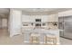 Modern kitchen with white cabinets, quartz countertops, stainless steel appliances, and island seating at 4371 E Enmark Dr, San Tan Valley, AZ 85143
