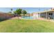 Expansive backyard features a refreshing in-ground pool and lush green lawn, ideal for recreation at 4419 W Vogel Ave, Glendale, AZ 85302