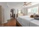 This bedroom features wood floors, a ceiling fan and a window for natural lighting at 4419 W Vogel Ave, Glendale, AZ 85302
