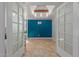 Versatile bonus room featuring eye-catching accent wall and glass doors for natural light at 4419 W Vogel Ave, Glendale, AZ 85302