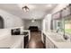 Modern kitchen with stainless steel appliances, white cabinets and views into the living room and backyard at 4419 W Vogel Ave, Glendale, AZ 85302