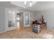 Bright home office featuring tile floors, a desk, and glass doors that lead to another room at 4419 W Vogel Ave, Glendale, AZ 85302