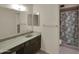 Bathroom with a long vanity, neutral walls and carpet, and a shower stall at 4509 E Joan De Arc Ave, Phoenix, AZ 85032