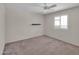 Bedroom with a ceiling fan, carpet floors, and plantation shutters at 4509 E Joan De Arc Ave, Phoenix, AZ 85032
