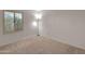 Cozy carpeted bedroom featuring plantation shutters and an accent lamp at 4509 E Joan De Arc Ave, Phoenix, AZ 85032
