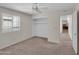 Bedroom with built-in closet, carpet floors, a ceiling fan, and window shutters at 4509 E Joan De Arc Ave, Phoenix, AZ 85032