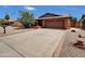 Charming single-story home with a brick exterior and well-maintained desert landscaping, plus a large driveway at 4509 E Joan De Arc Ave, Phoenix, AZ 85032