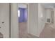 Hallway featuring carpet floors and access to the bedroom at 4509 E Joan De Arc Ave, Phoenix, AZ 85032