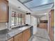 Bright kitchen featuring granite countertops, stainless appliances, a window view, and tile flooring at 4509 E Joan De Arc Ave, Phoenix, AZ 85032
