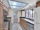 Well-lit kitchen features granite countertops, stainless steel appliances, and tile floors at 4509 E Joan De Arc Ave, Phoenix, AZ 85032