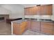 Kitchen area with granite counters and wood cabinets, complemented by tiled flooring and a bright, airy ambiance at 4509 E Joan De Arc Ave, Phoenix, AZ 85032