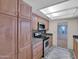 A bright kitchen featuring stainless steel appliances, granite countertops, and wood cabinets at 4509 E Joan De Arc Ave, Phoenix, AZ 85032