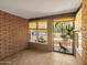 Cozy covered patio with brick walls and decorative ironwork offering a private and shaded outdoor retreat at 4509 E Joan De Arc Ave, Phoenix, AZ 85032