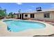 Enjoy this pool with cool water and surrounded by a patio, privacy fencing, and desert landscaping at 4509 E Joan De Arc Ave, Phoenix, AZ 85032