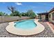 A backyard pool creates a relaxing oasis, surrounded by a patio, desert rock, and privacy fencing at 4509 E Joan De Arc Ave, Phoenix, AZ 85032