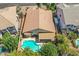 Aerial view of backyard with a pool, covered patio, trees and desert landscaping at 45131 W Horse Mesa Rd, Maricopa, AZ 85139
