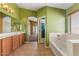 Well-lit bathroom with a tiled floor, vanity, a separate shower, and a soaking tub at 45131 W Horse Mesa Rd, Maricopa, AZ 85139