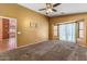 Spacious bedroom featuring plush carpeting, a ceiling fan, and a bay window at 45131 W Horse Mesa Rd, Maricopa, AZ 85139