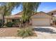 Inviting single-story home featuring a well-manicured front yard with desert landscaping at 45131 W Horse Mesa Rd, Maricopa, AZ 85139