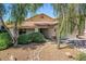 Charming home features a well-maintained front yard with mature trees and a stone accent driveway at 45131 W Horse Mesa Rd, Maricopa, AZ 85139