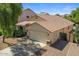 Well-manicured single-story home featuring a tile roof, two car garage and desert landscaping at 45131 W Horse Mesa Rd, Maricopa, AZ 85139