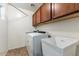 Functional laundry room equipped with a washer, dryer, utility sink, and ample storage at 45131 W Horse Mesa Rd, Maricopa, AZ 85139