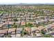 Aerial view of home, surrounded by lush green lawns, mature trees, and community amenities at 45131 W Horse Mesa Rd, Maricopa, AZ 85139