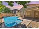 Inviting backyard pool with waterfall feature and lush landscaping at 45131 W Horse Mesa Rd, Maricopa, AZ 85139