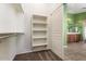 Spacious walk-in closet with built-in shelving and sliding door to the bathroom at 45131 W Horse Mesa Rd, Maricopa, AZ 85139