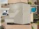 Aerial view of the property with a pool, a patio, the roof, the driveway, and two cars at 46141 W Rainbow Dr, Maricopa, AZ 85139