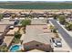 Aerial view of a neighborhood featuring homes, pools, and agricultural land nearby at 46141 W Rainbow Dr, Maricopa, AZ 85139